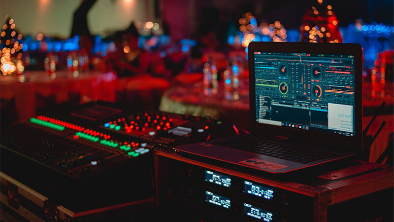 audio visual console with laptop and studio mixer at event wedding